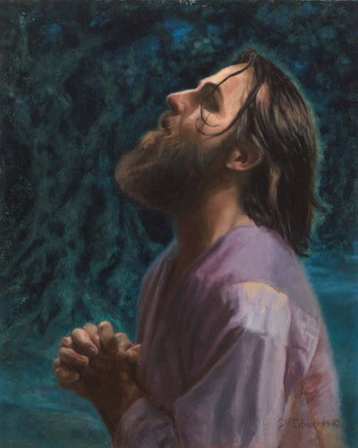 Jesus in the Garden of Gethsemane with his hands together praying.